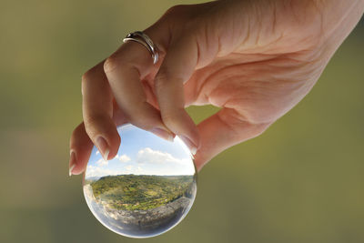 Close-up of hand holding crystal ball