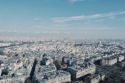 High angle view of city buildings against cloudy sky