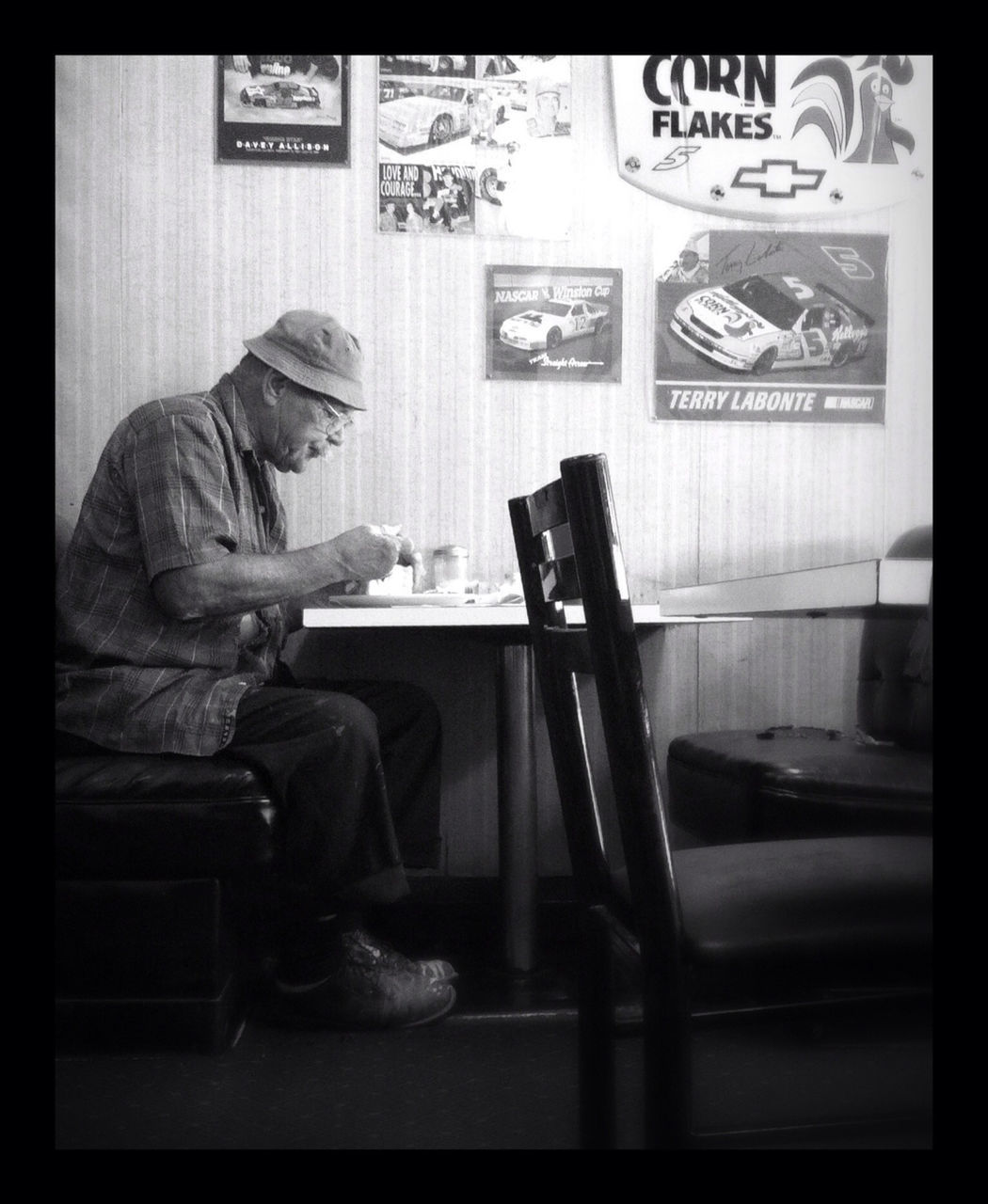 indoors, transfer print, communication, auto post production filter, text, home interior, human representation, men, western script, table, sitting, holding, book, art and craft, technology, person, non-western script