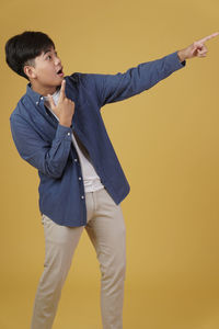 Young man looking away over white background