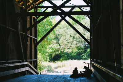 Silhouette people sitting in window