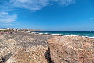 Scenic view of beach against blue sky