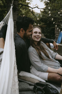Young couple sitting outdoors