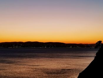 Scenic view of sea against clear sky during sunset