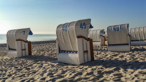 Hooded beach chairs on sandy beach