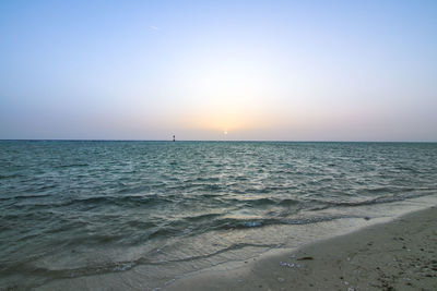 Scenic view of sea against clear sky during sunset