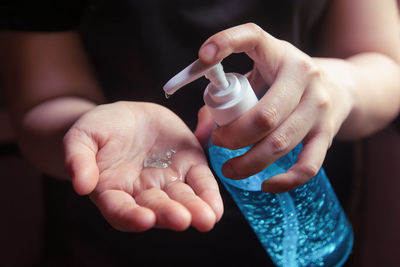 Close-up of woman hand holding bottle