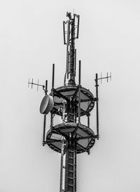 Low angle view of communications tower against sky