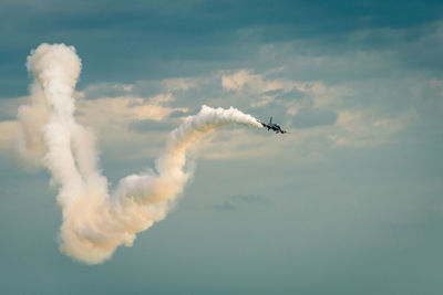 Low angle view of airshow against sky