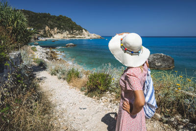 Rear view of woman looking at sea shore