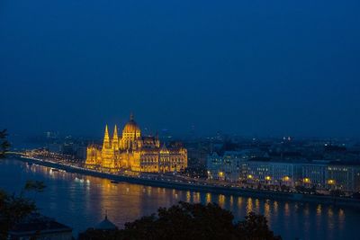 High angle view of illuminated city building against clear sky