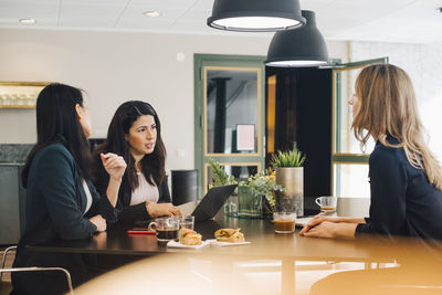 Business colleagues discussing in meeting at board room