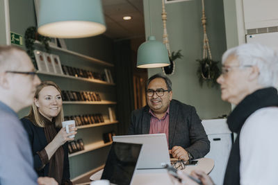 Smiling people during meeting in office