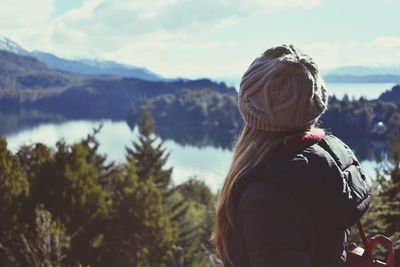 Woman looking at river against sky