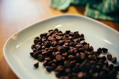 Close-up of coffee beans in plate on table