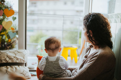 Woman playing son at home