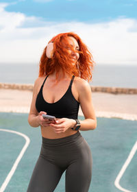 Young woman exercising at beach