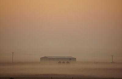 Scenic view of building on a misty morning 