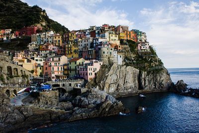 Panoramic view of sea by cliff against sky