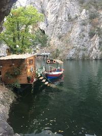 View of boats in river against rock formation