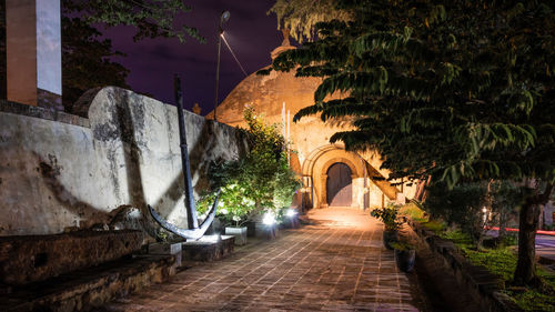 Street amidst old buildings at night