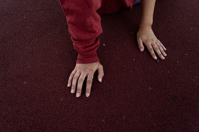 High angle view of woman hands on sports track