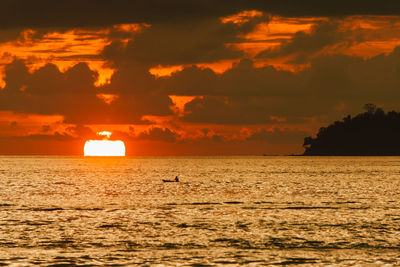 Scenic view of sea against orange sky