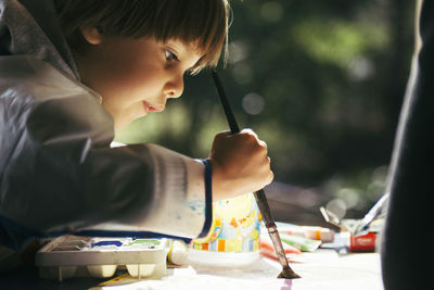 Side view of boy painting