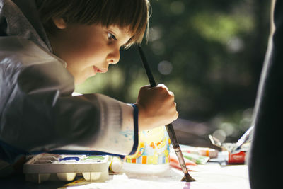 Side view of girl holding ice cream on table