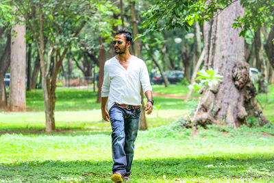 Full length of man standing by tree