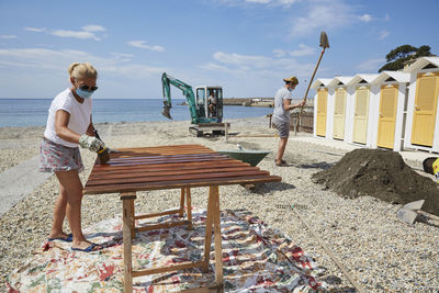 Full length of woman on beach against sky