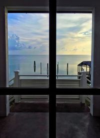 Scenic view of sea against sky seen through window