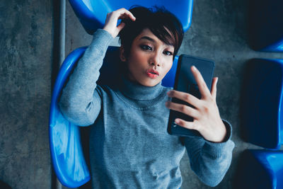 Portrait of young woman using mobile phone