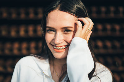 Portrait of smiling young woman with hand in hair