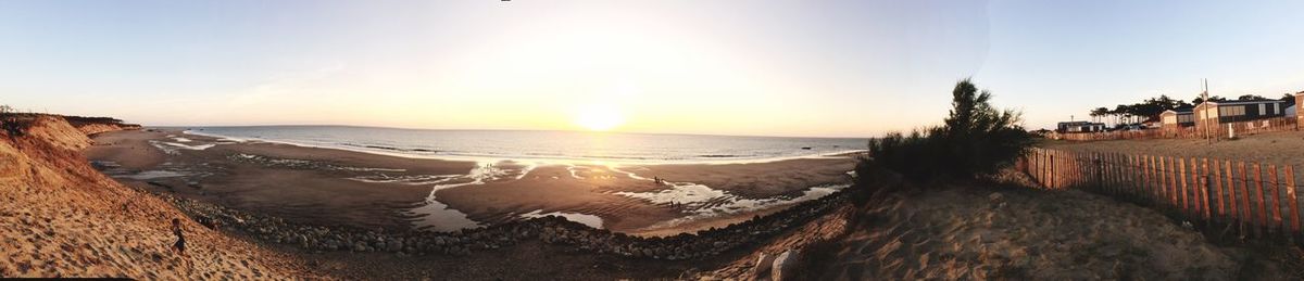 Panoramic view of beach against sky during sunset