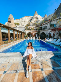 Rear view of woman standing in swimming pool