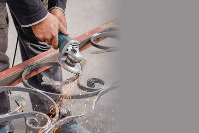 Metal grinding with angle grinder. sparks fly on the sides. male hand and instrument close-up. 