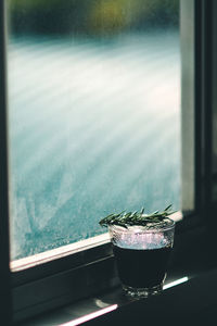 Close-up of glass on window sill