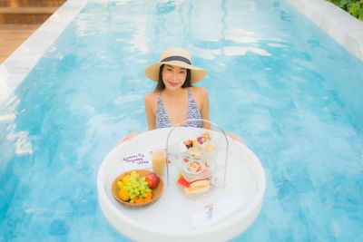 Portrait of smiling young man in swimming pool