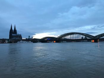 View of bridge over river against cloudy sky