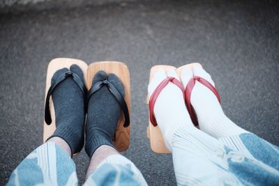 Low section of people wearing geta