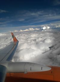 Airplane flying over mountain against sky