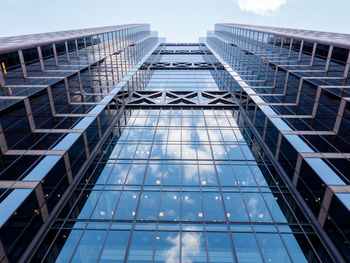 Low angle view of modern glass building against sky