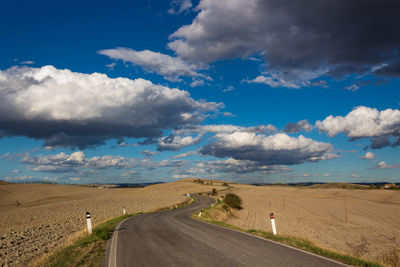 Scenic view of road by land against sky