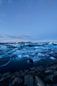 Scenic view of snowcapped mountains against blue sky