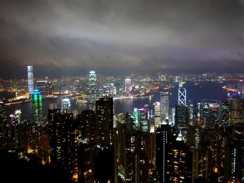 Illuminated cityscape against sky at night