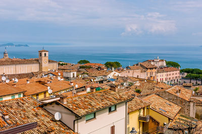 High angle view of townscape by sea against sky