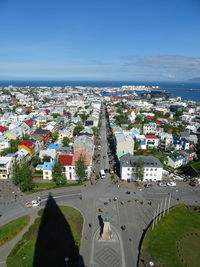 High angle view of town by sea against sky