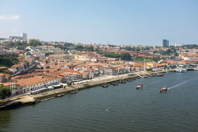 High angle view of townscape by river against sky