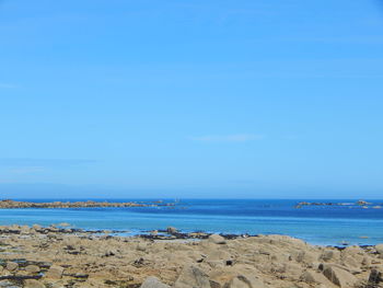 Scenic view of seascape against clear blue sky